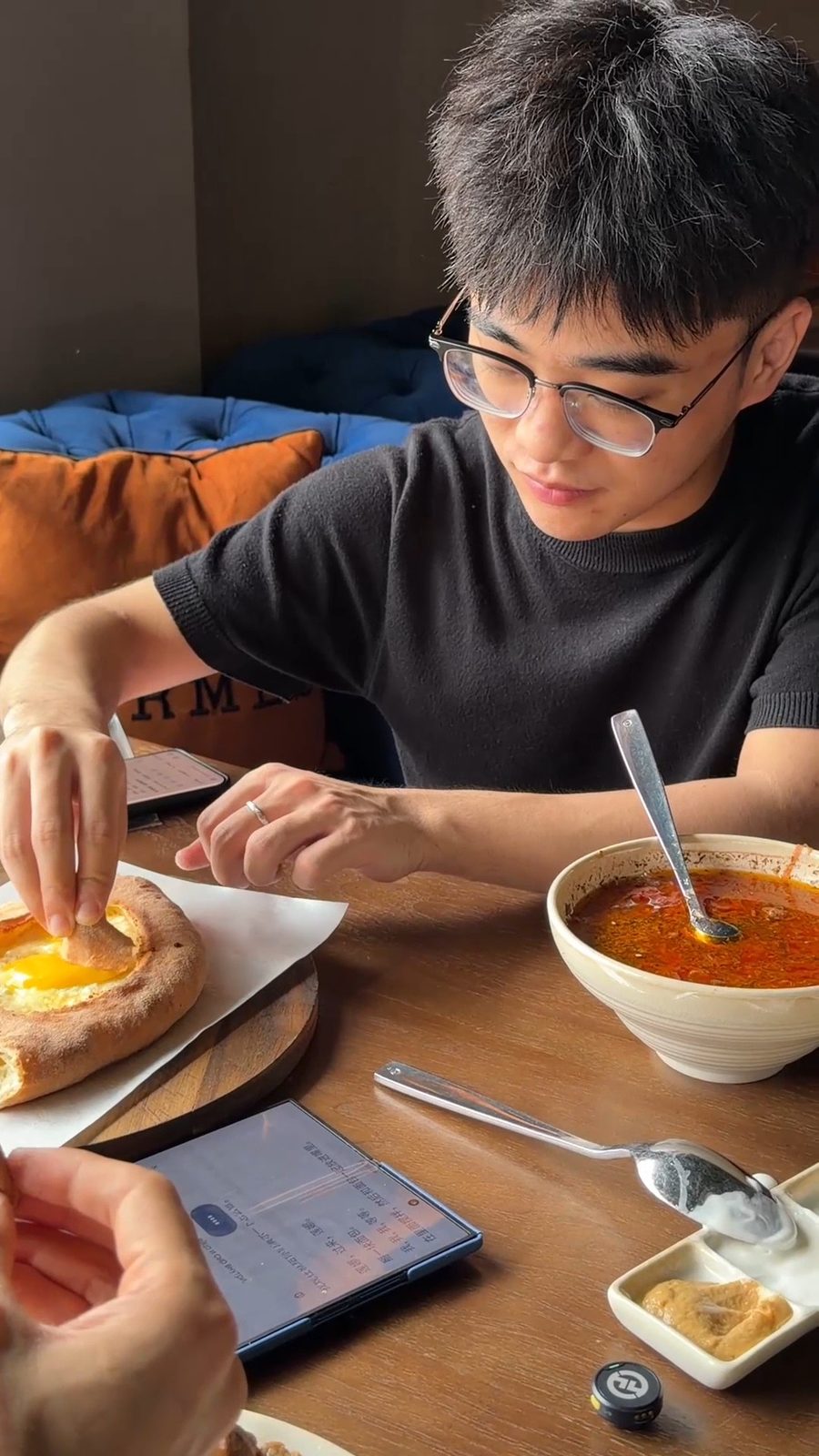 A guest trying khachapuri and borscht at NASHE MESTO